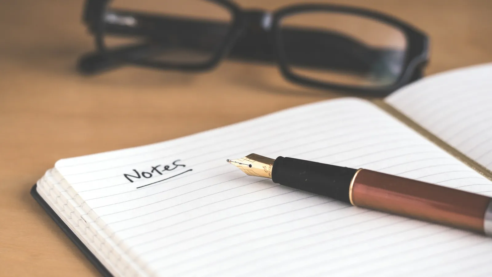 Handwriting personal details in a notebook, symbolizing the first step of family tree compilation